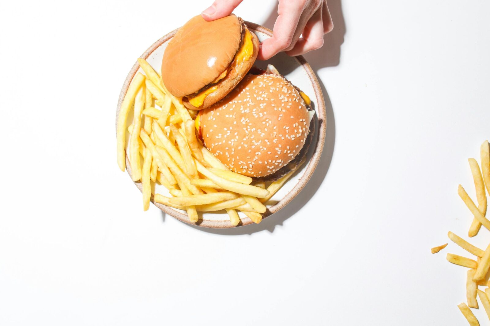 Maximalist Food burger stacked with multiple patties, colorful sauces, melted cheese and extravagant toppings